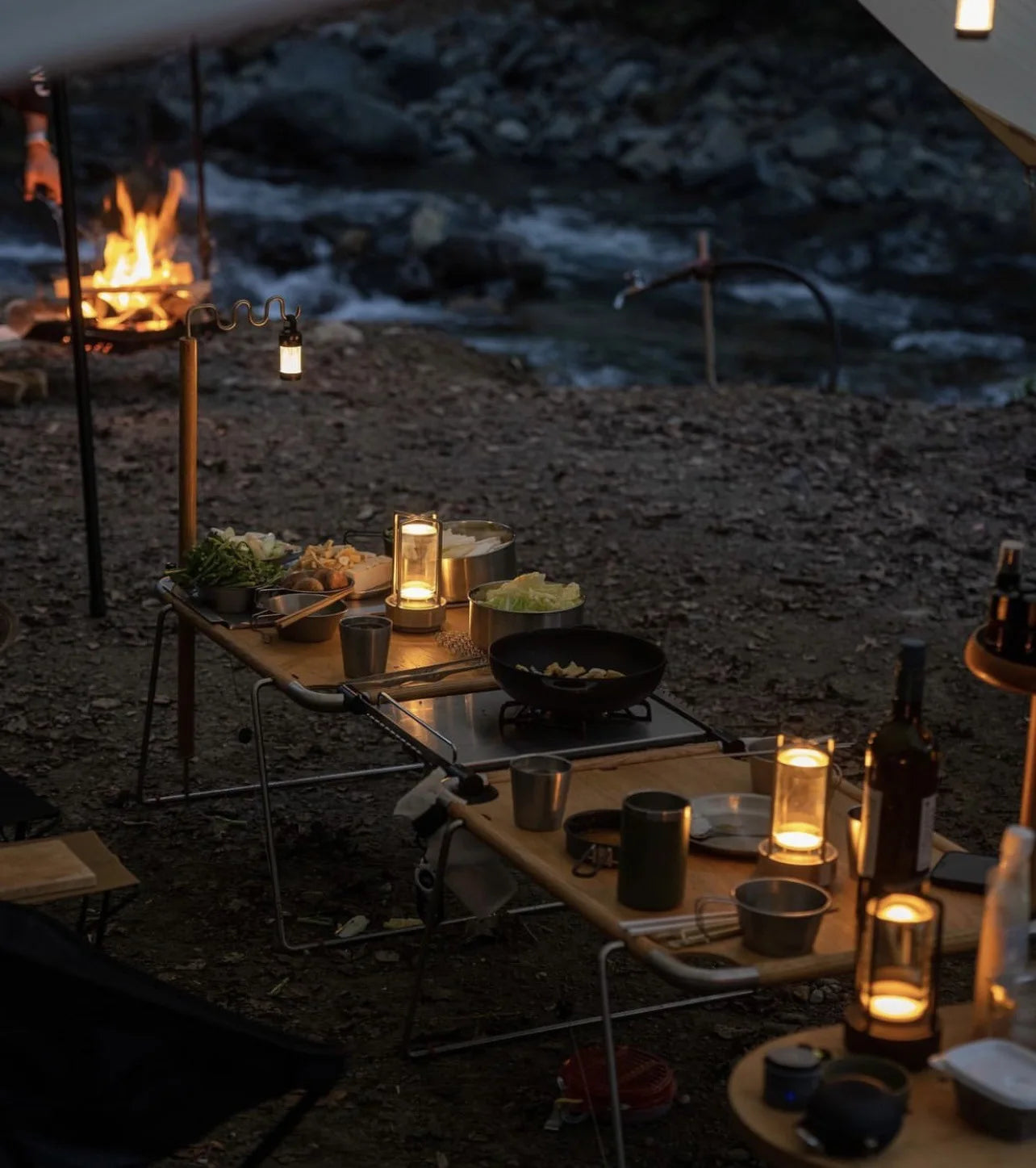 Broadcrate crystal mood lamp glowing on table with food and drinks, used outdoors