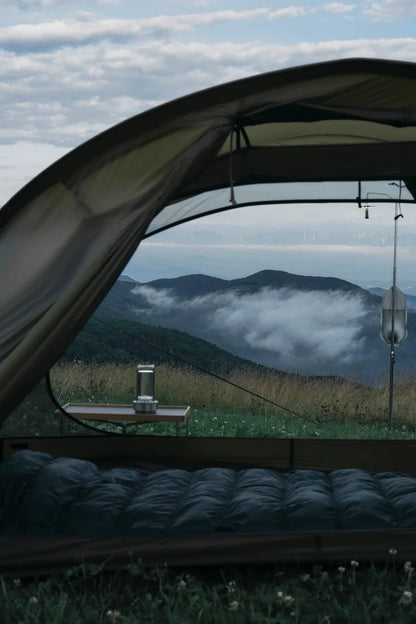 Camping scene with a tent overlooking misty mountains with broadcrate crystal lamp